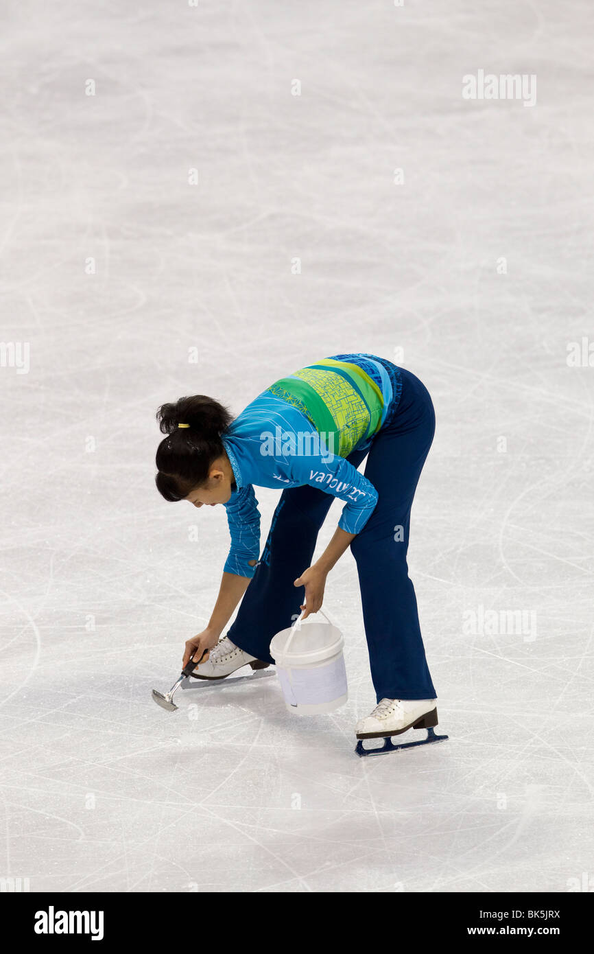 Girl working on ice resurfacing maintenance during the competition in the Figure Skating Ice Dance Free Dance Stock Photo