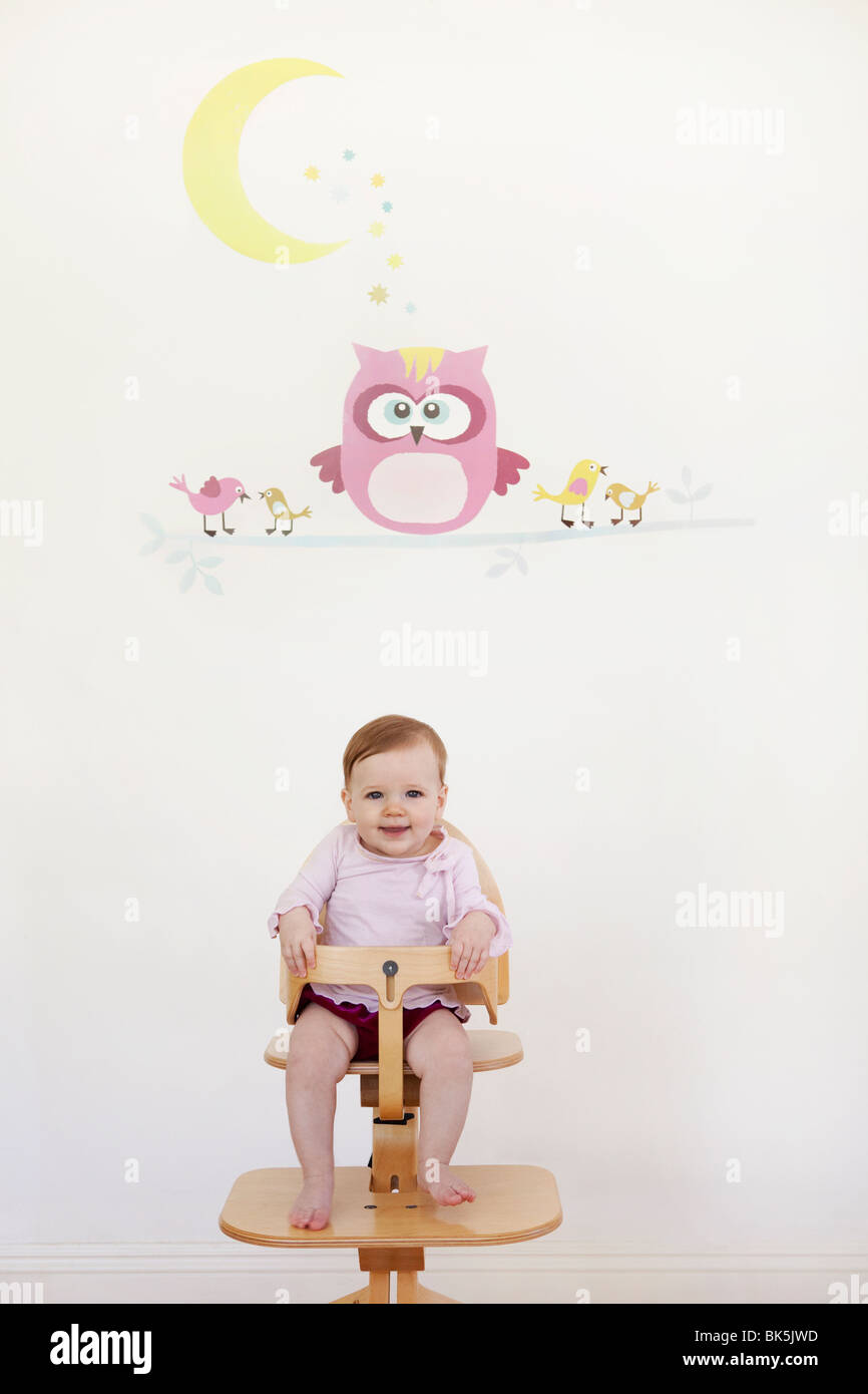 Little girl in high chair Stock Photo