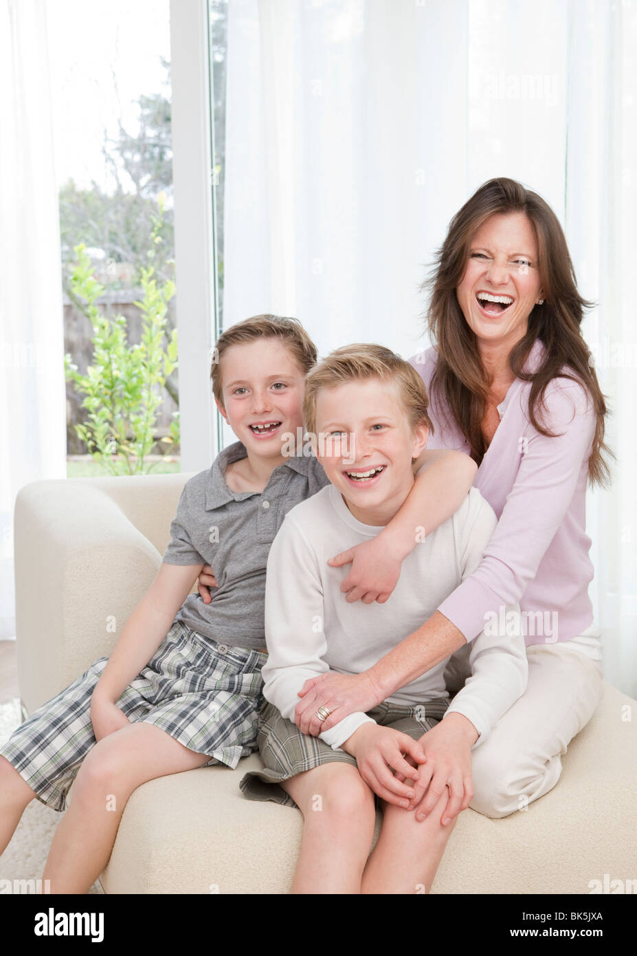Mother and sons on sofa Stock Photo