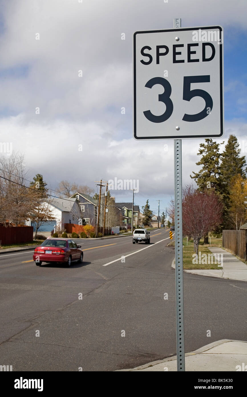 A 35 mph sign along a street in a city residential area Stock Photo