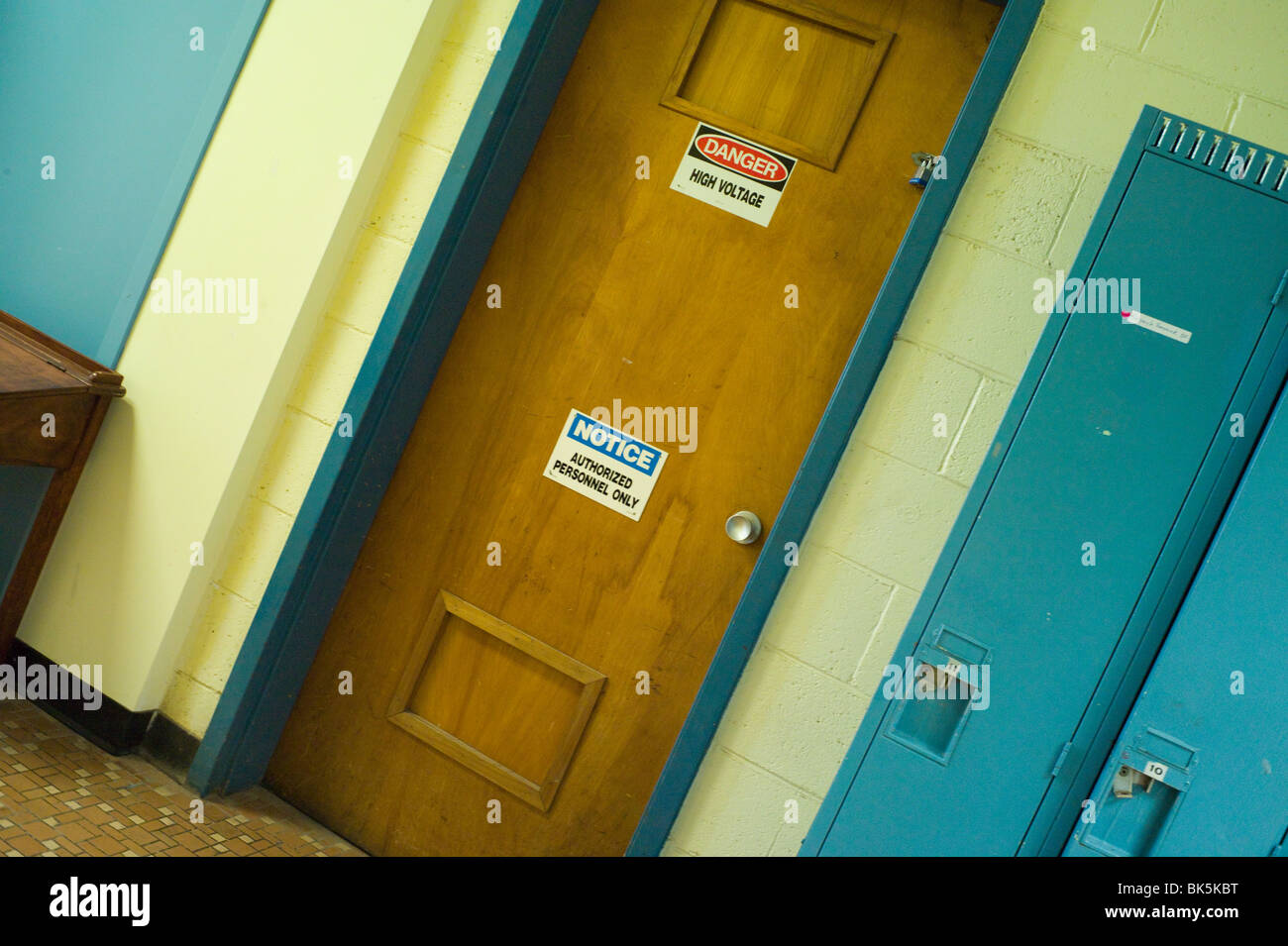 Door with warning notices beside school lockers. Stock Photo