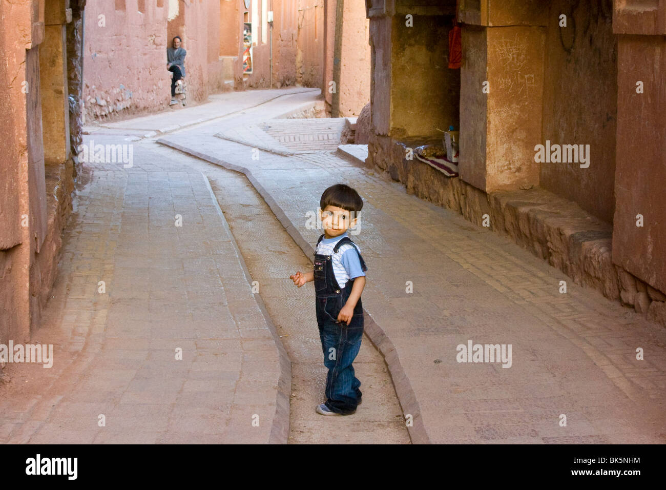 Young boy and old man in Abiyaneh, Iran Stock Photo