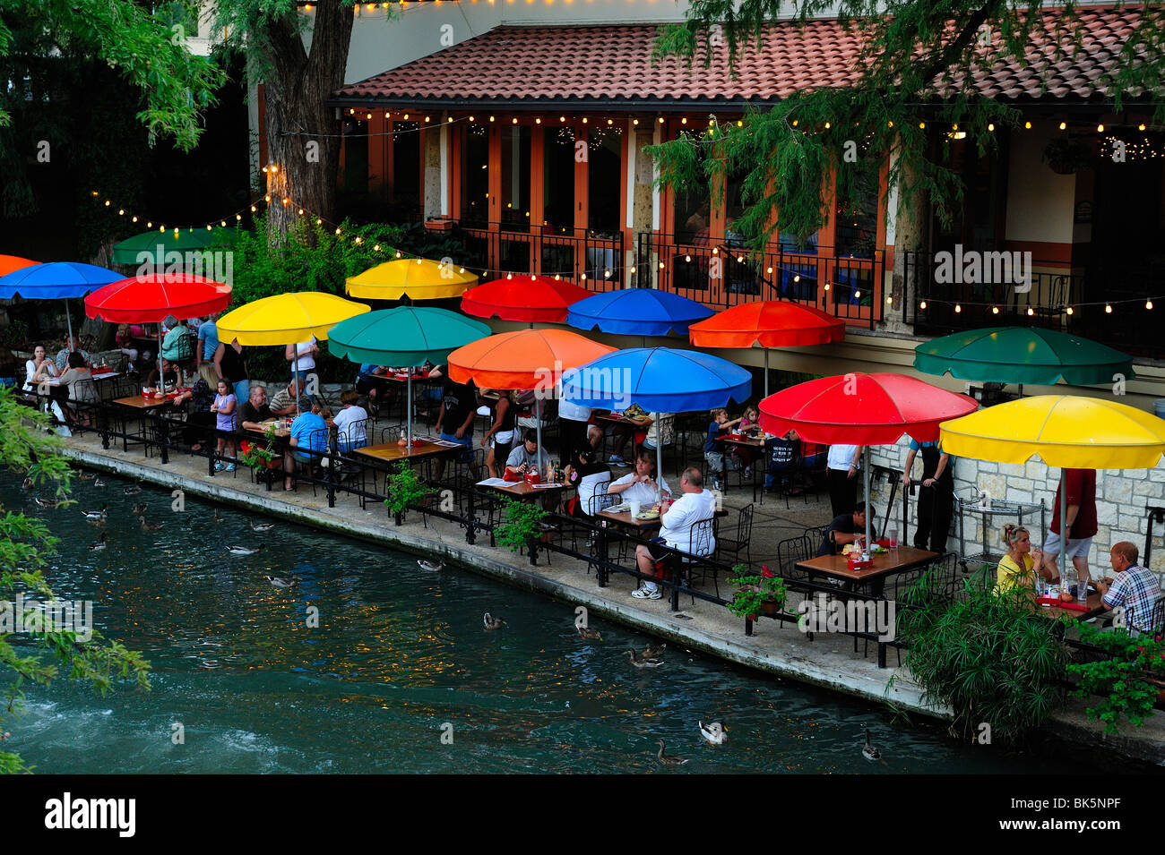 People eating in a restaurant on the riverwalk in San Antonio. Stock Photo