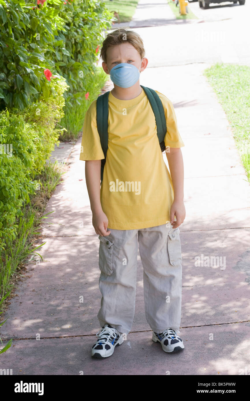 Little Boy Walking to School Wearing a Face Mask Stock Photo