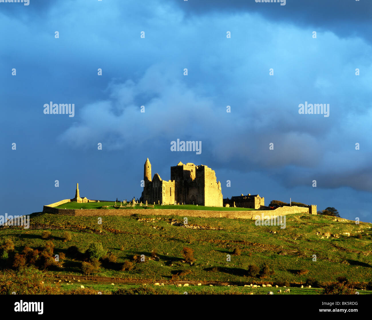 Mediaeval cathedral, round tower and Cormac’s Chapel sit on the Rock of Cashel, County Tipperary, Ireland. Sunset after rain. Stock Photo