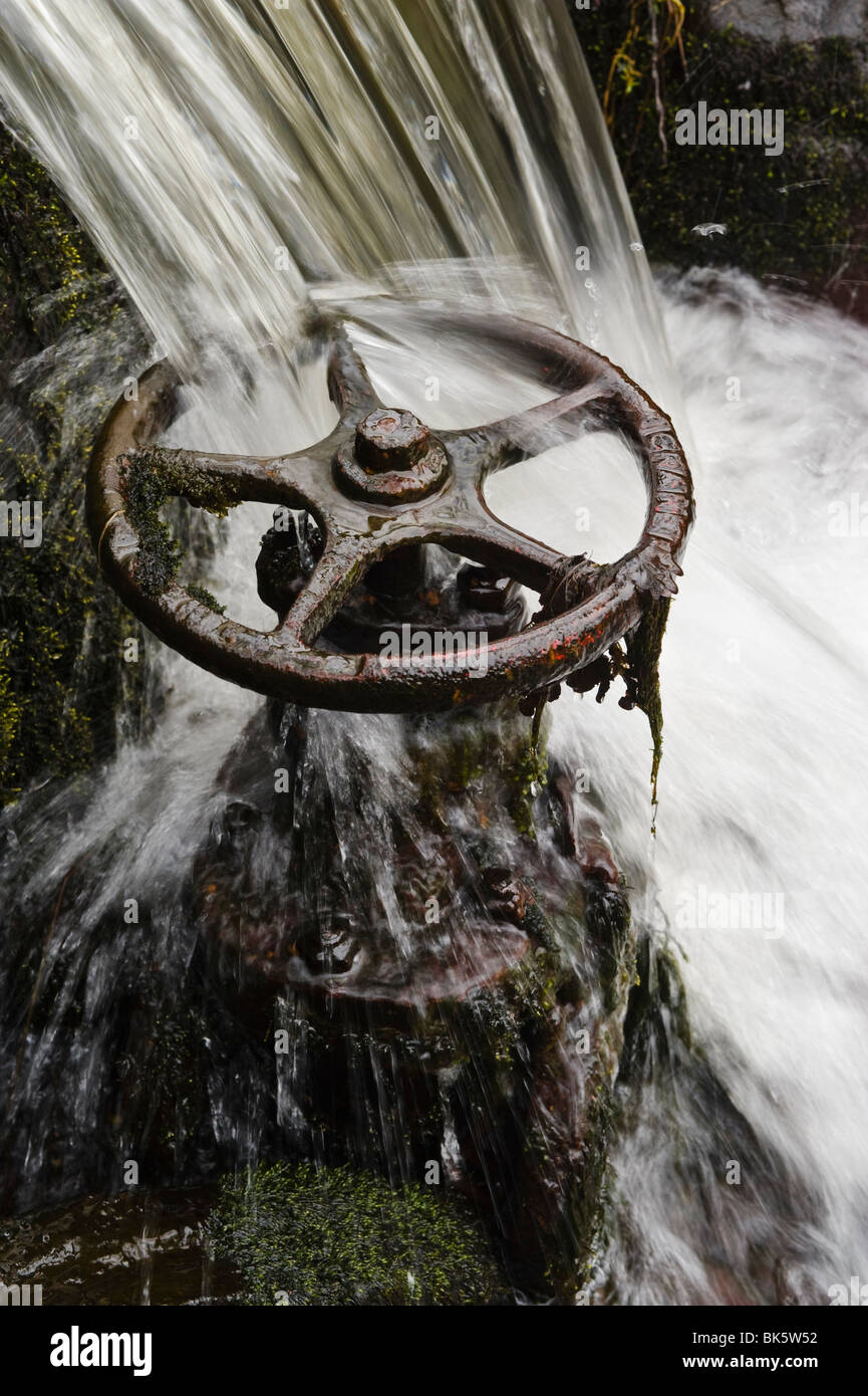 Waterfall and old sluice valve Stock Photo