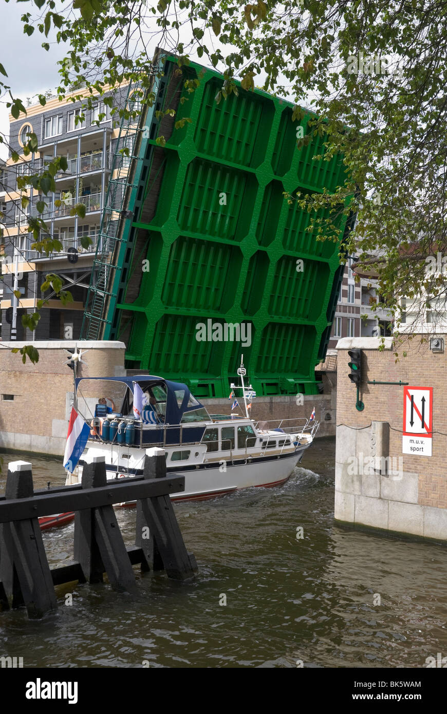 A single leaf bascule bridge opens for a leisure boat to pass by. Amsterdam, the Netherlands. Stock Photo