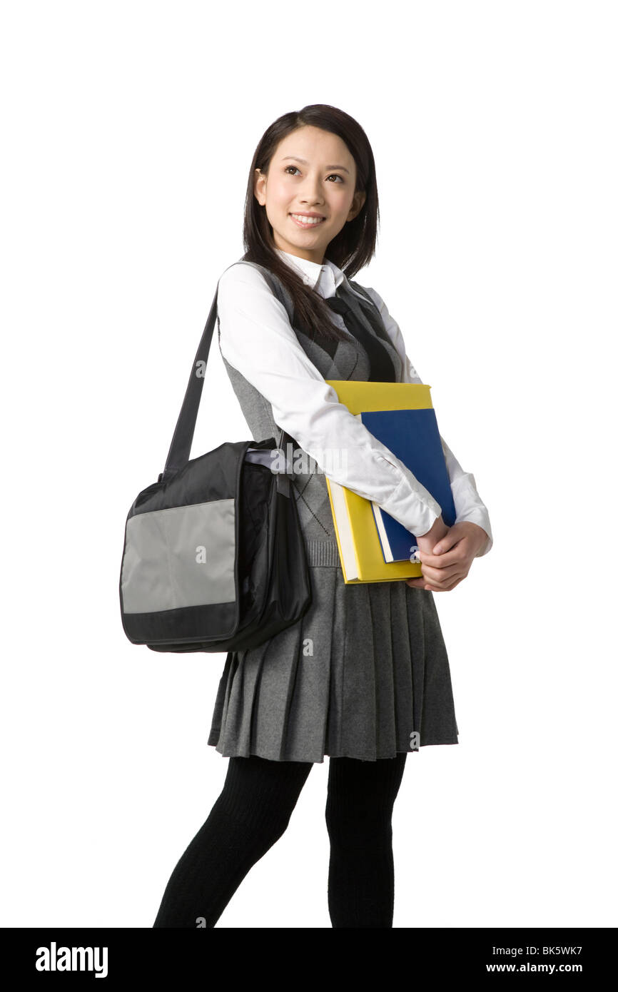 Schoolgirl holding her books Stock Photo - Alamy