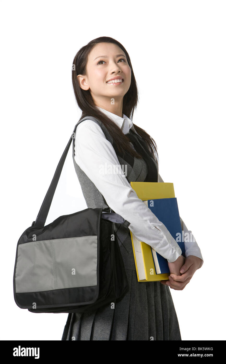 Schoolgirl holding her books Stock Photo - Alamy