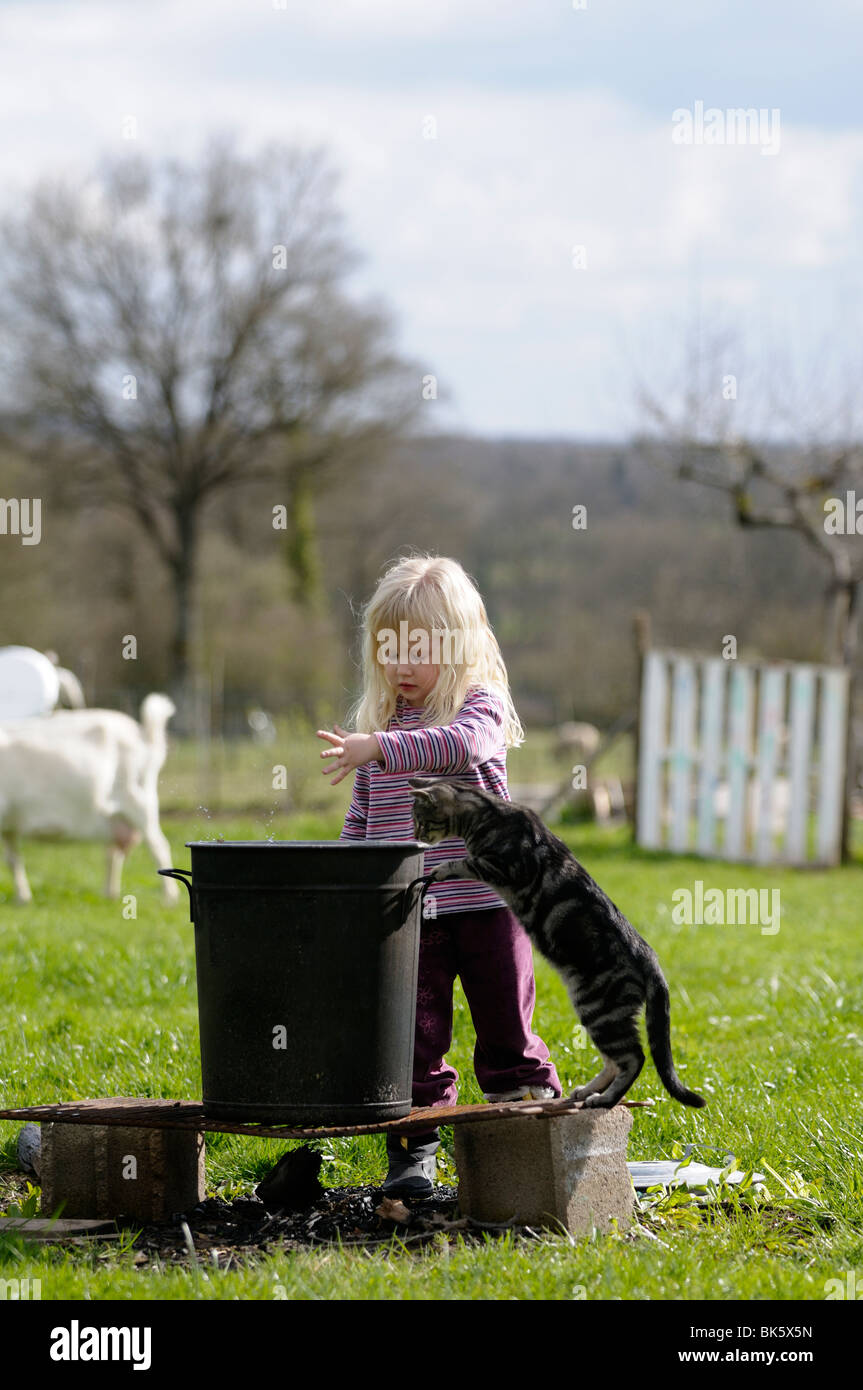 Stock Photo Of A Four Year Old Child Playing Make Believe Games In The Garden With Her Cat Stock Photo Alamy