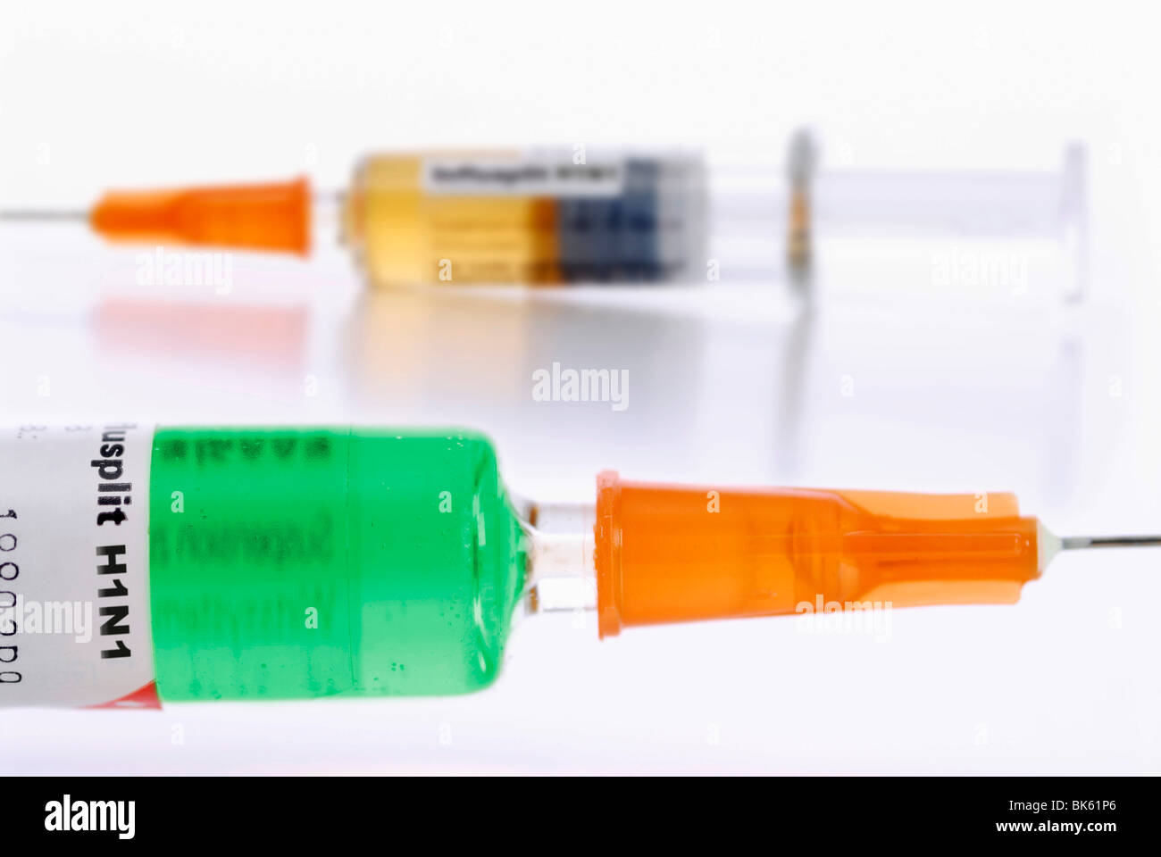 Two syringes with different vaccines against the swine flu Stock Photo