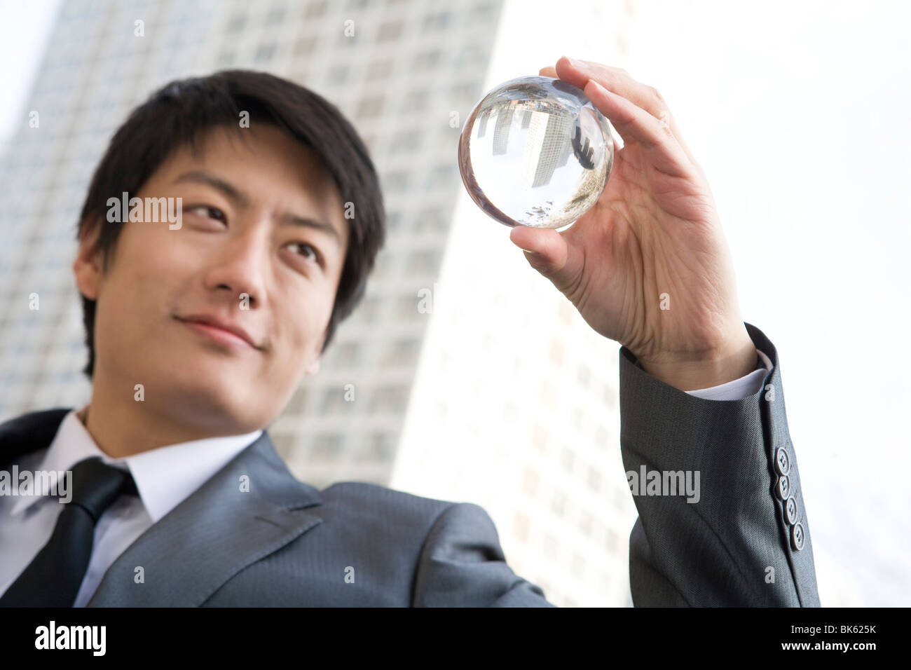 Businessman looking into crystal ball hi-res stock photography and ...