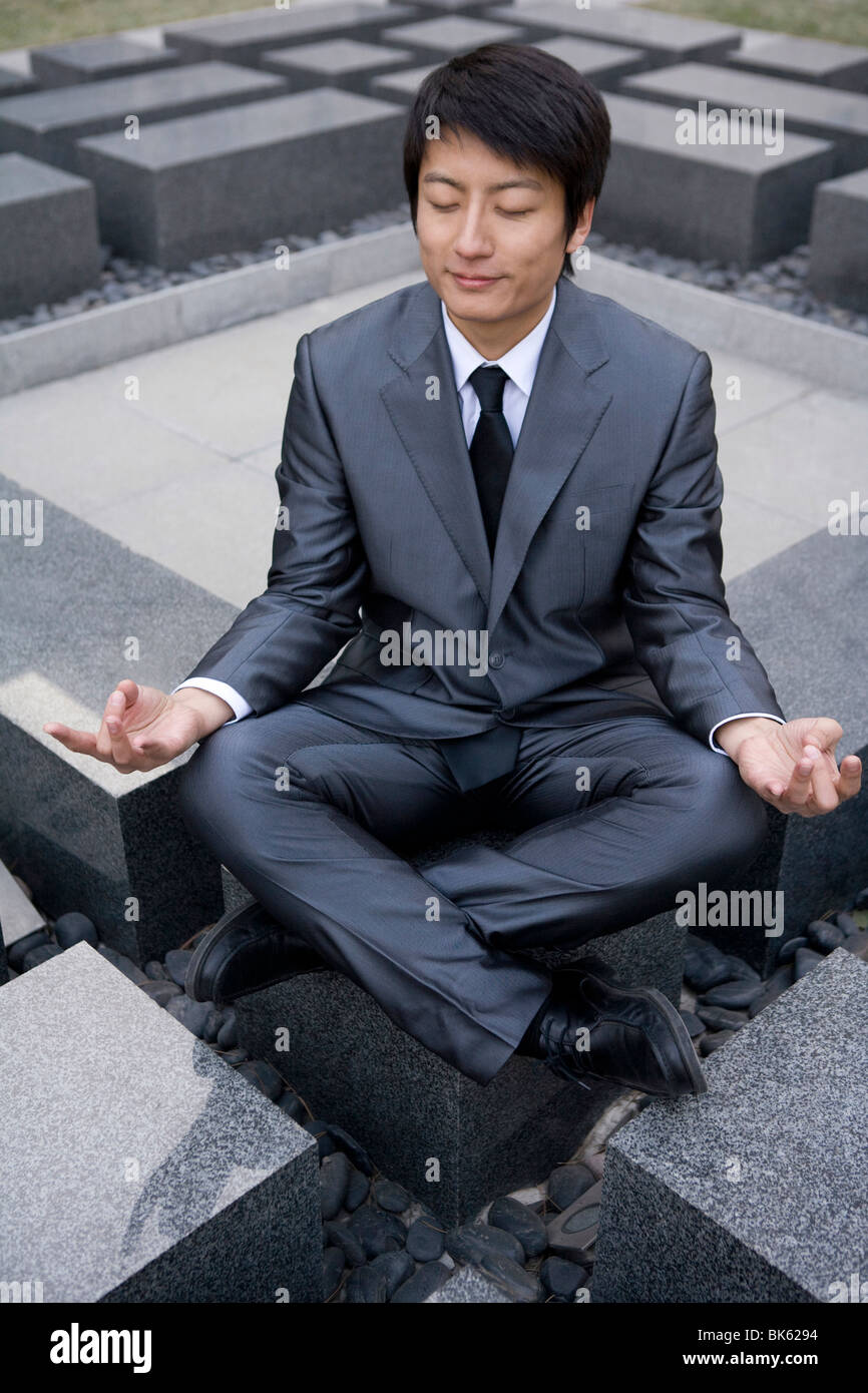 Businessman doing yoga Stock Photo - Alamy