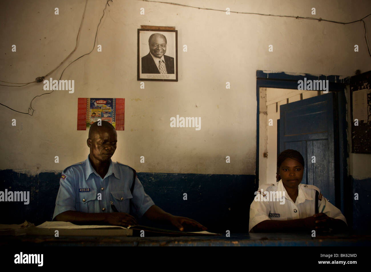Officers stand behind the main desk of the Lamu island police station on September 8, 2009, Kenya. Stock Photo