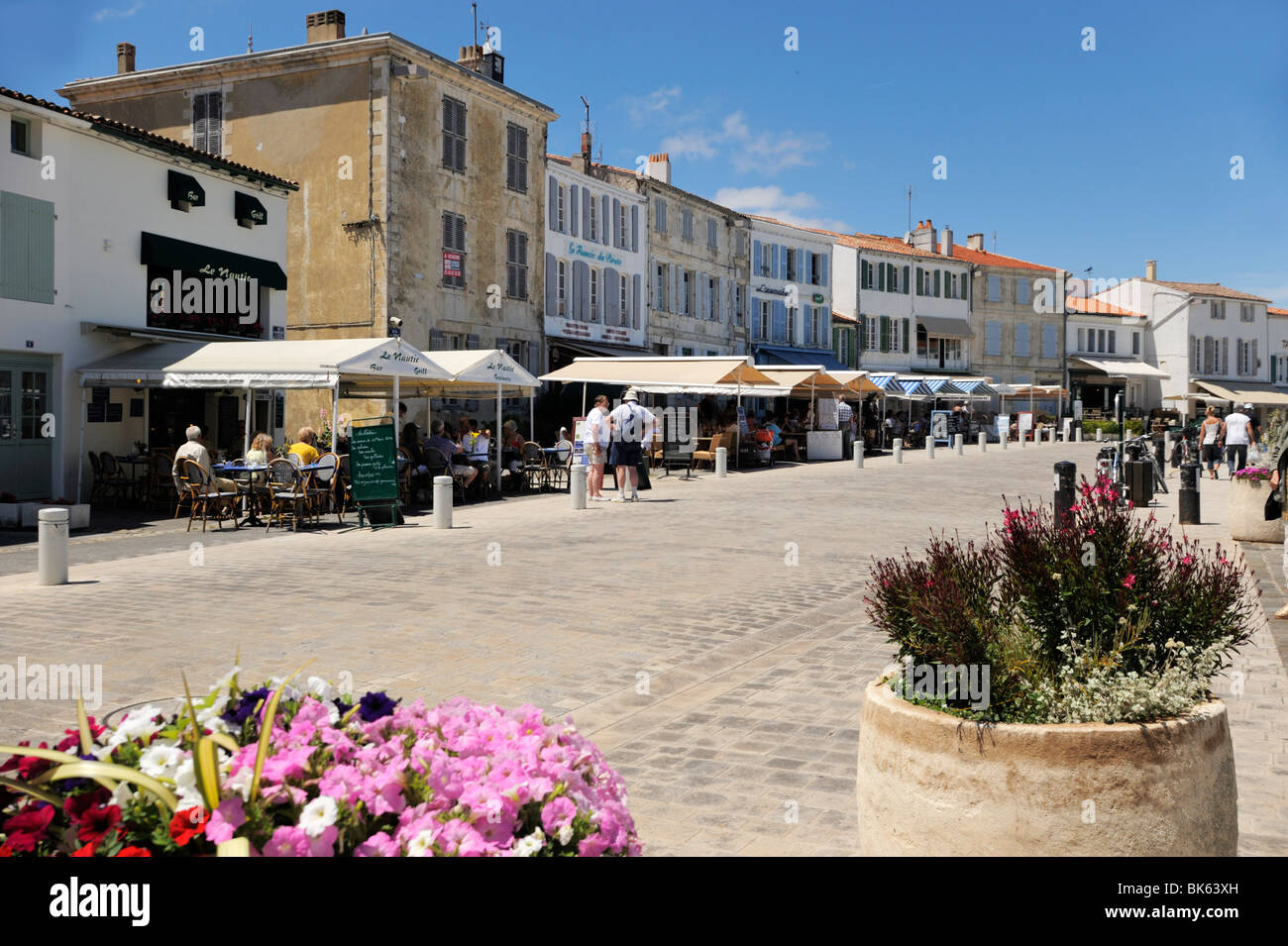 Quayside restaurants and traditional shuttered buildings, La Flotte, Ile de Re, Charente-Maritime, France, Europe Stock Photo