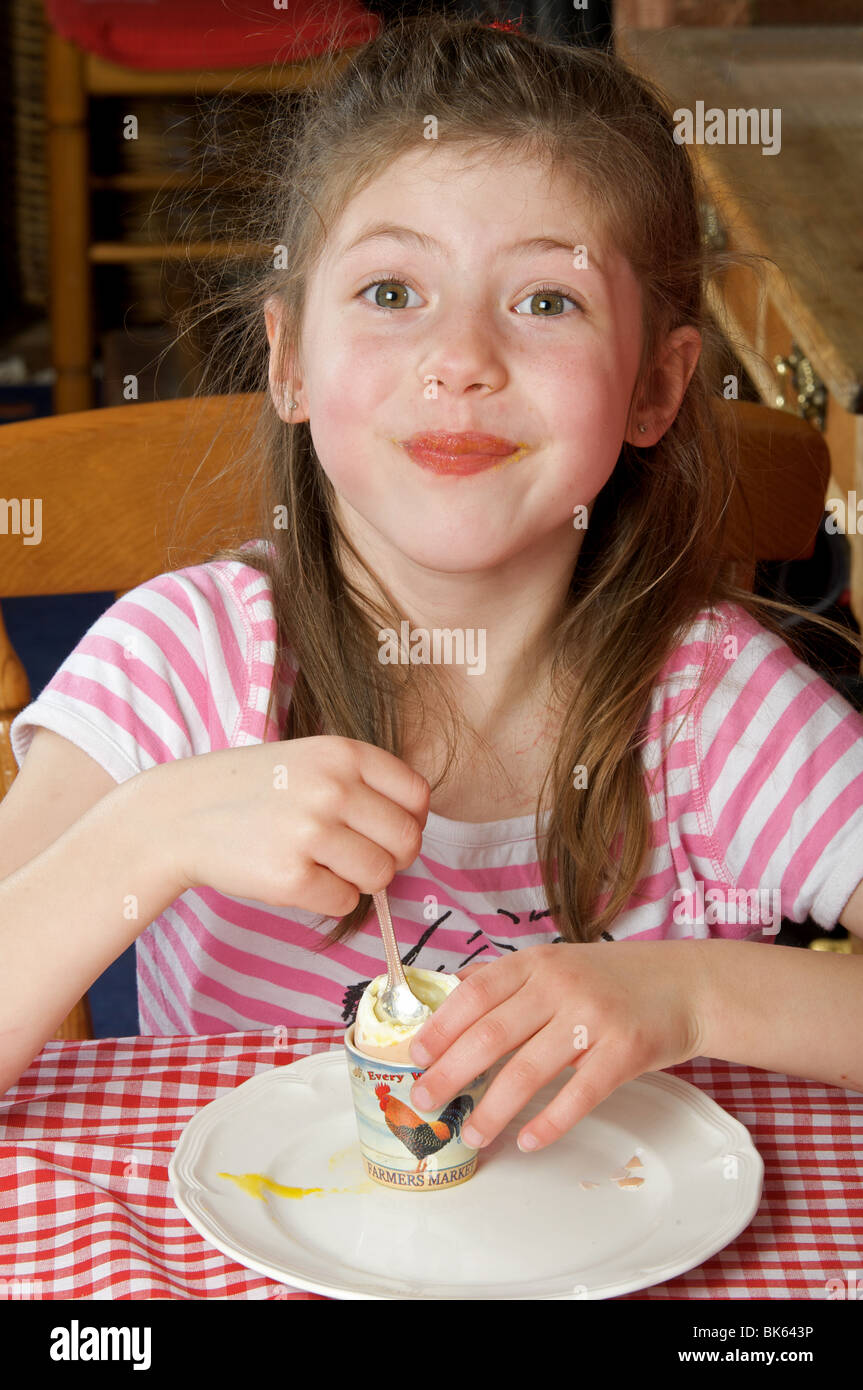 Young girl eating soft boiled egg for breakfast Stock Photo Alamy