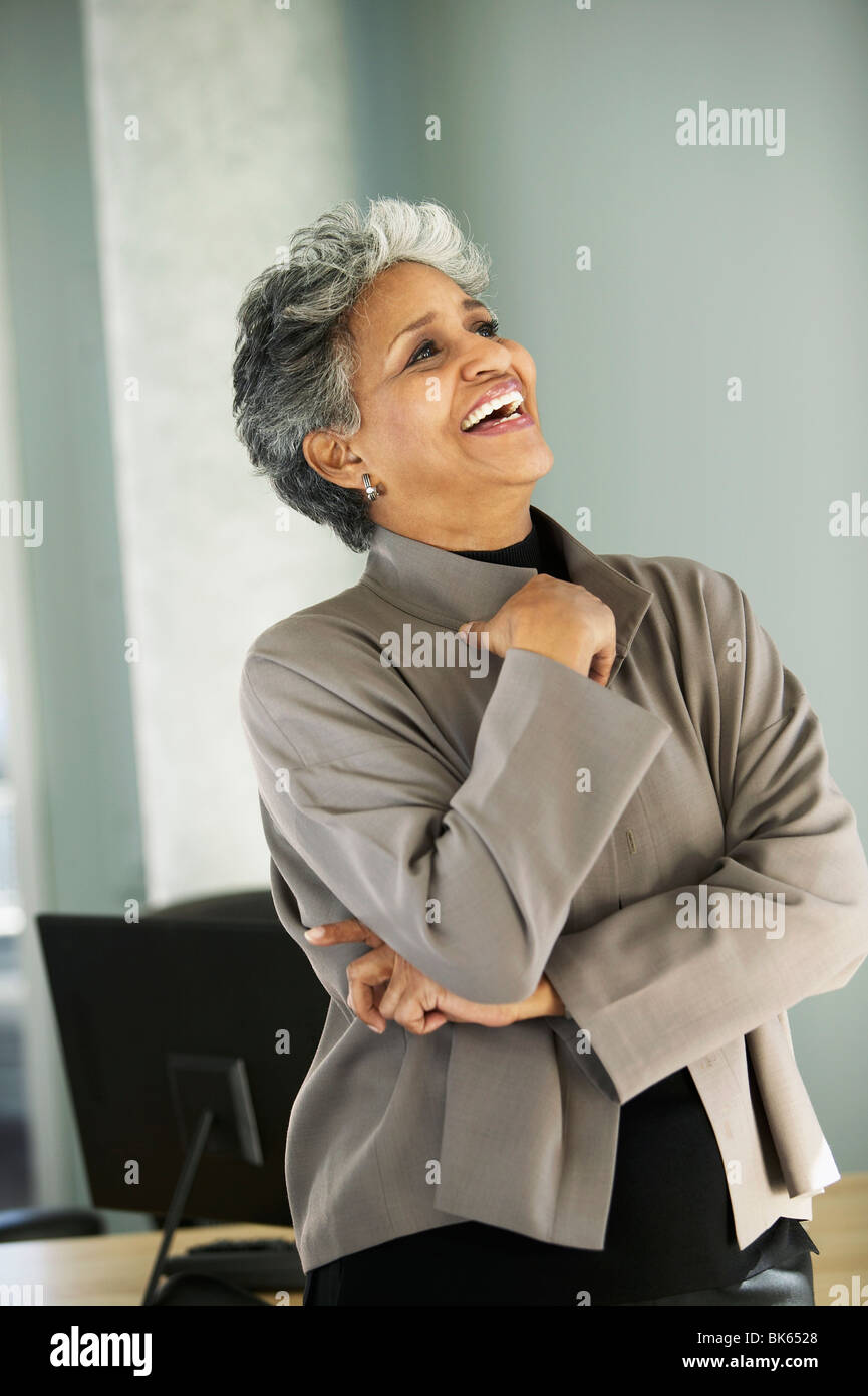 Businesswoman day dreaming in an office Stock Photo