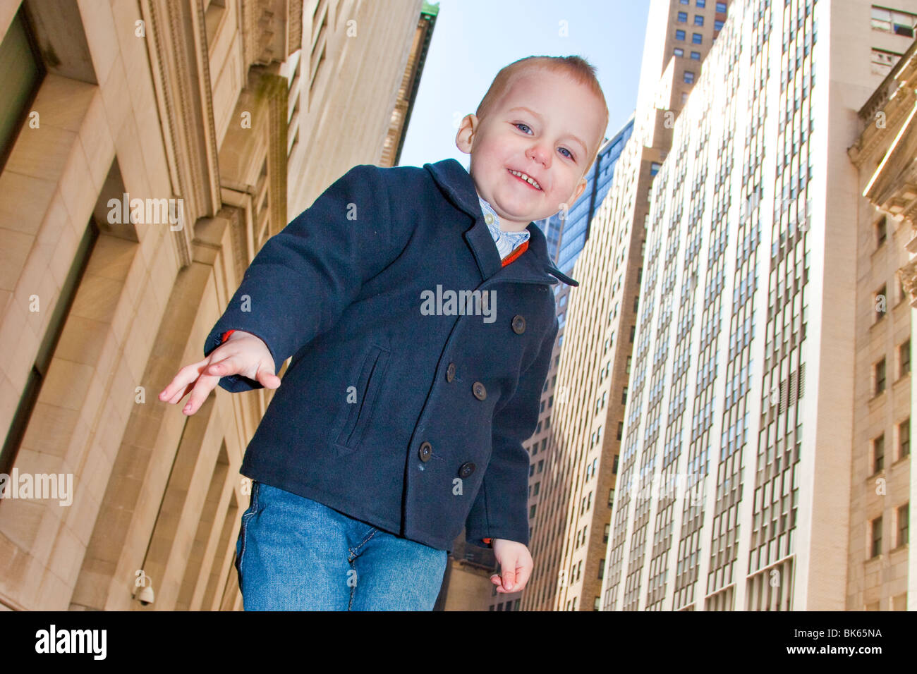 Young boy in front of Stock Exchange on Wall Street, Manhattan, New York Stock Photo Alamy