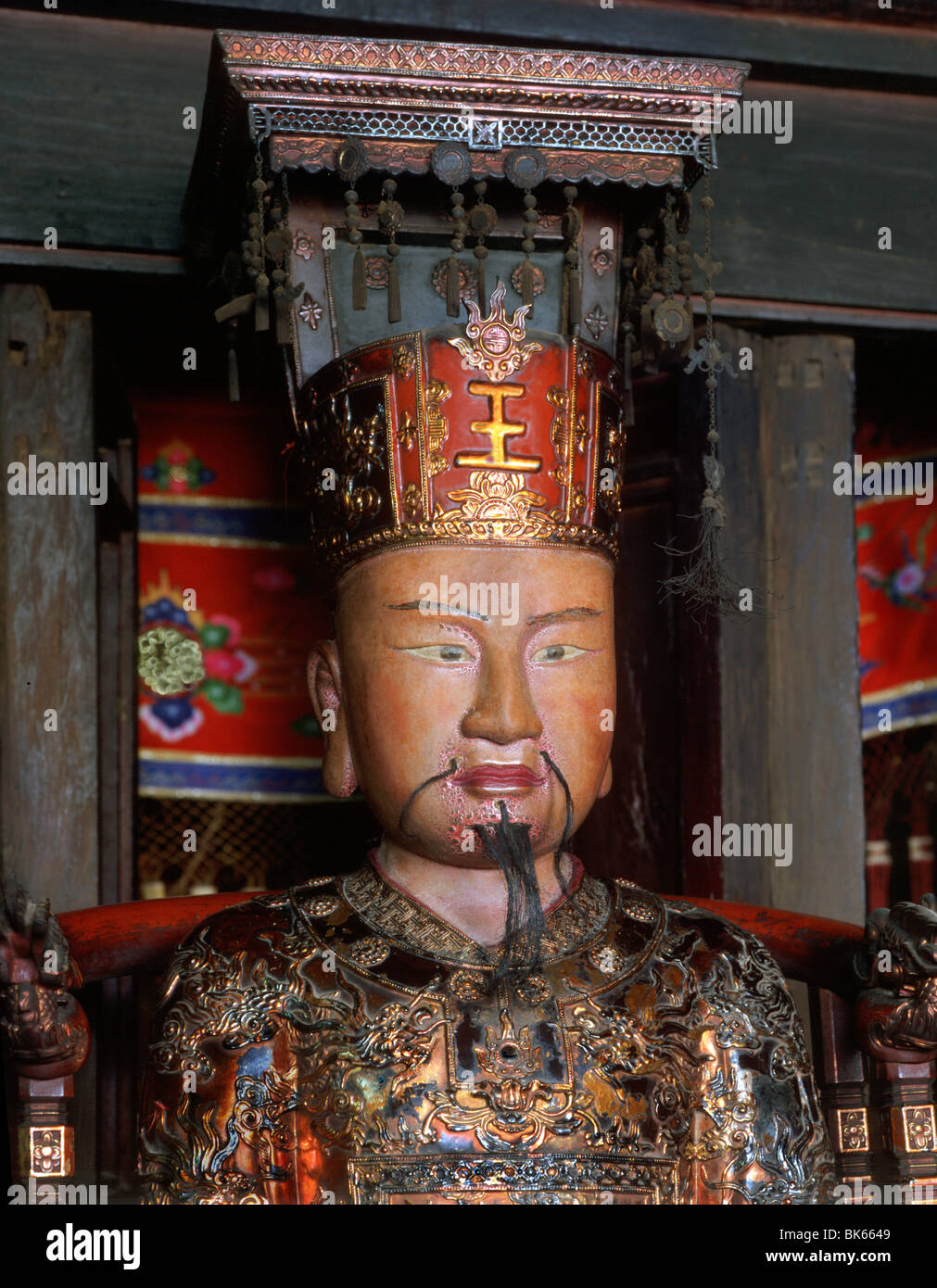 Gilded statue of Emperor in the Dinh Temple, the oldest dynastic temple