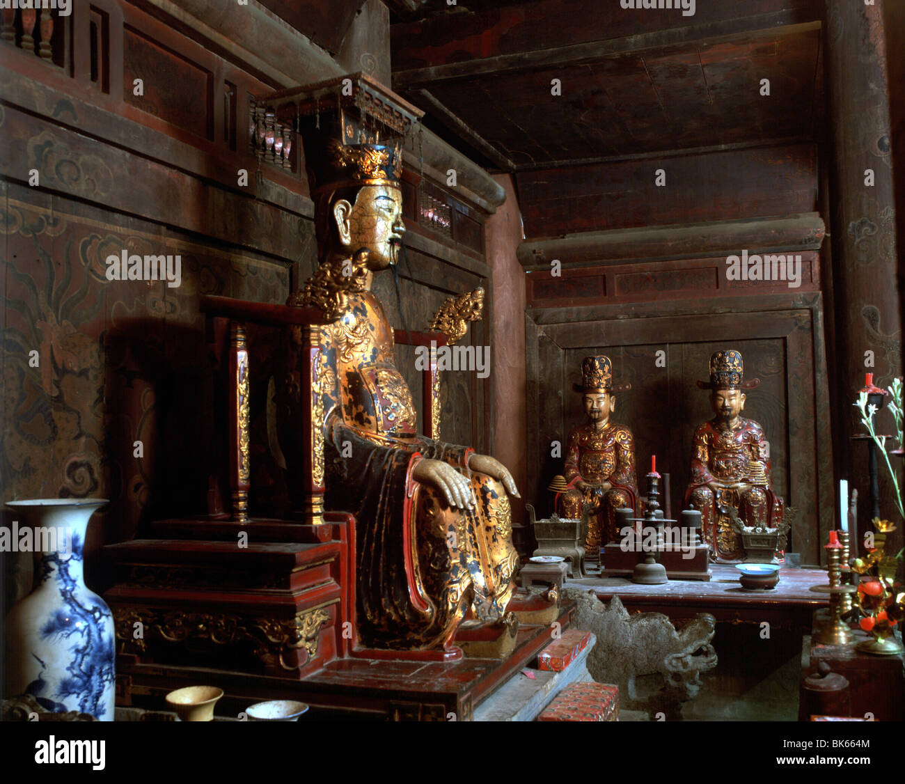 Gilded statue of Emperor in the hall of Dinh Temple, the oldest