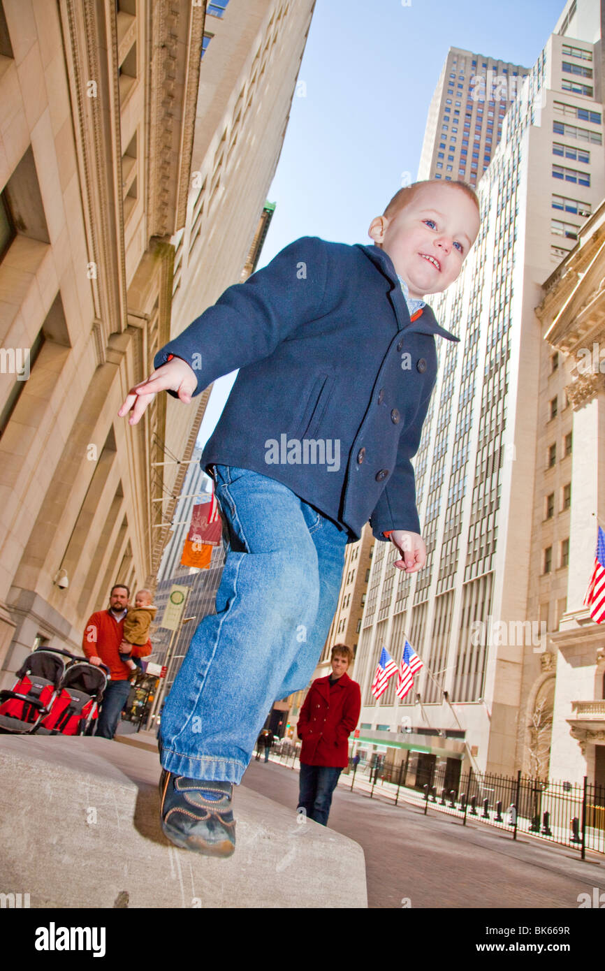 Young boy in front of Stock Exchange on Wall Street, Manhattan, New York Stock Photo Alamy