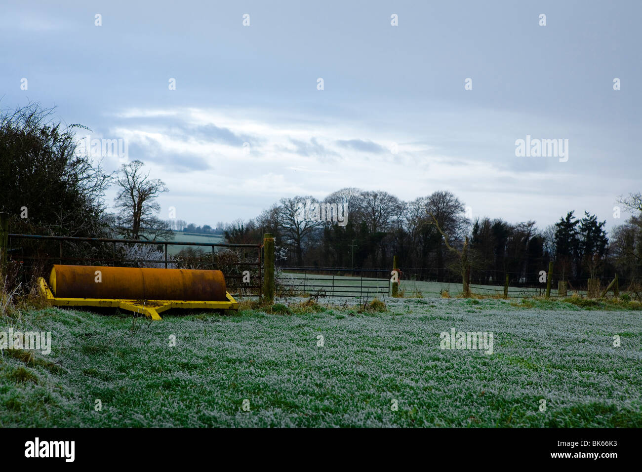 An abandoned roller left to rust in the English countryside just outside Bath on a Winters evening. Stock Photo