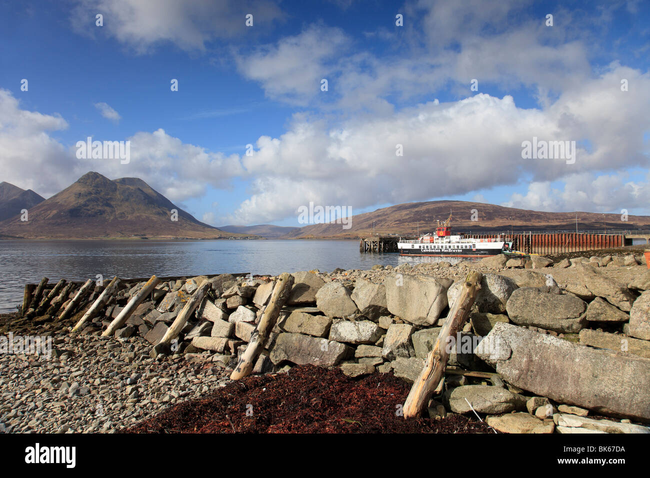 View from Inverarish on the Isle of Raasay to the Cuillin mountains on the Isle of Skye with Raasay ferry waiting to sail Stock Photo