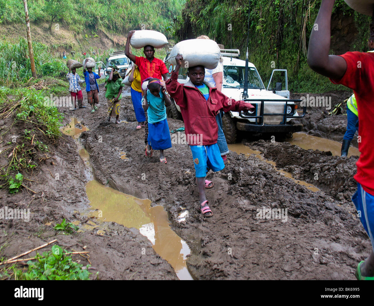 Muddy roads in Democratic Republic of Congo. Displaced people fleeing war Stock Photo