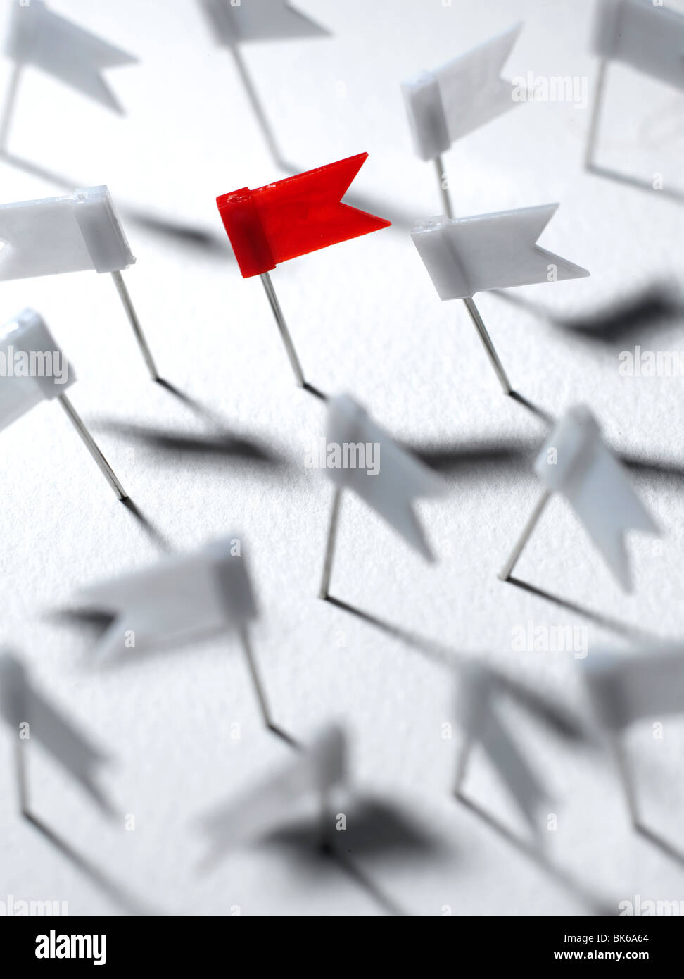 Red map pin flag among white map pin flags Stock Photo Alamy