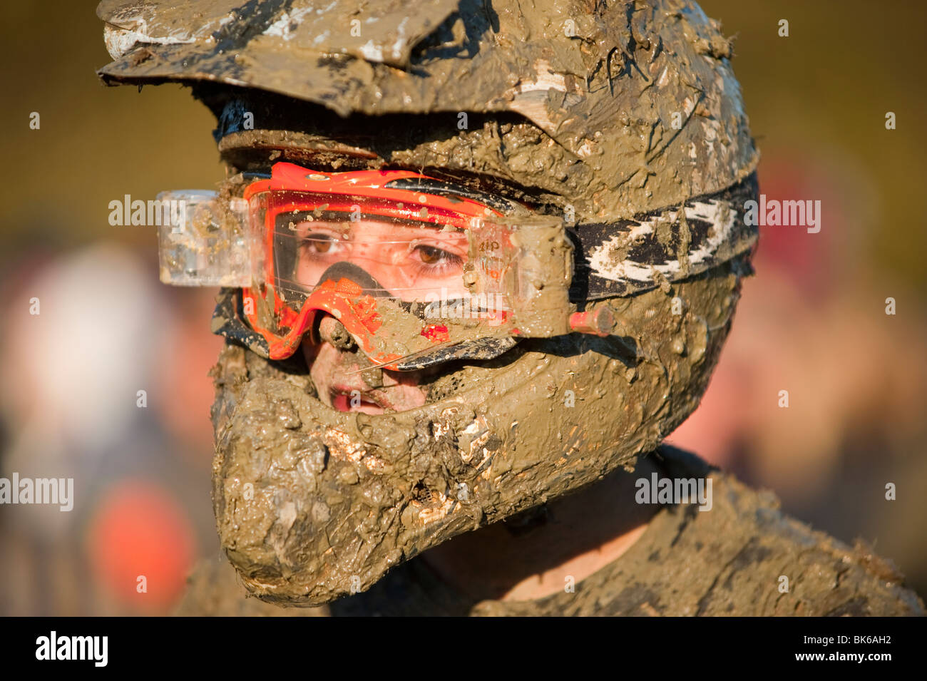 Motorbike rider covered in mud Stock Photo