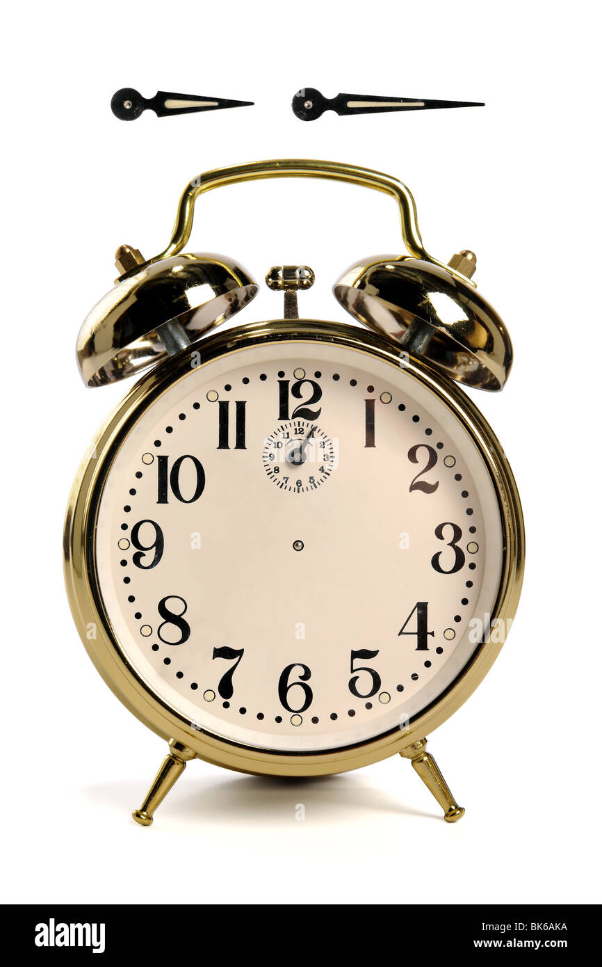 Vintage alarm clock isolated over white hour and minute hands have