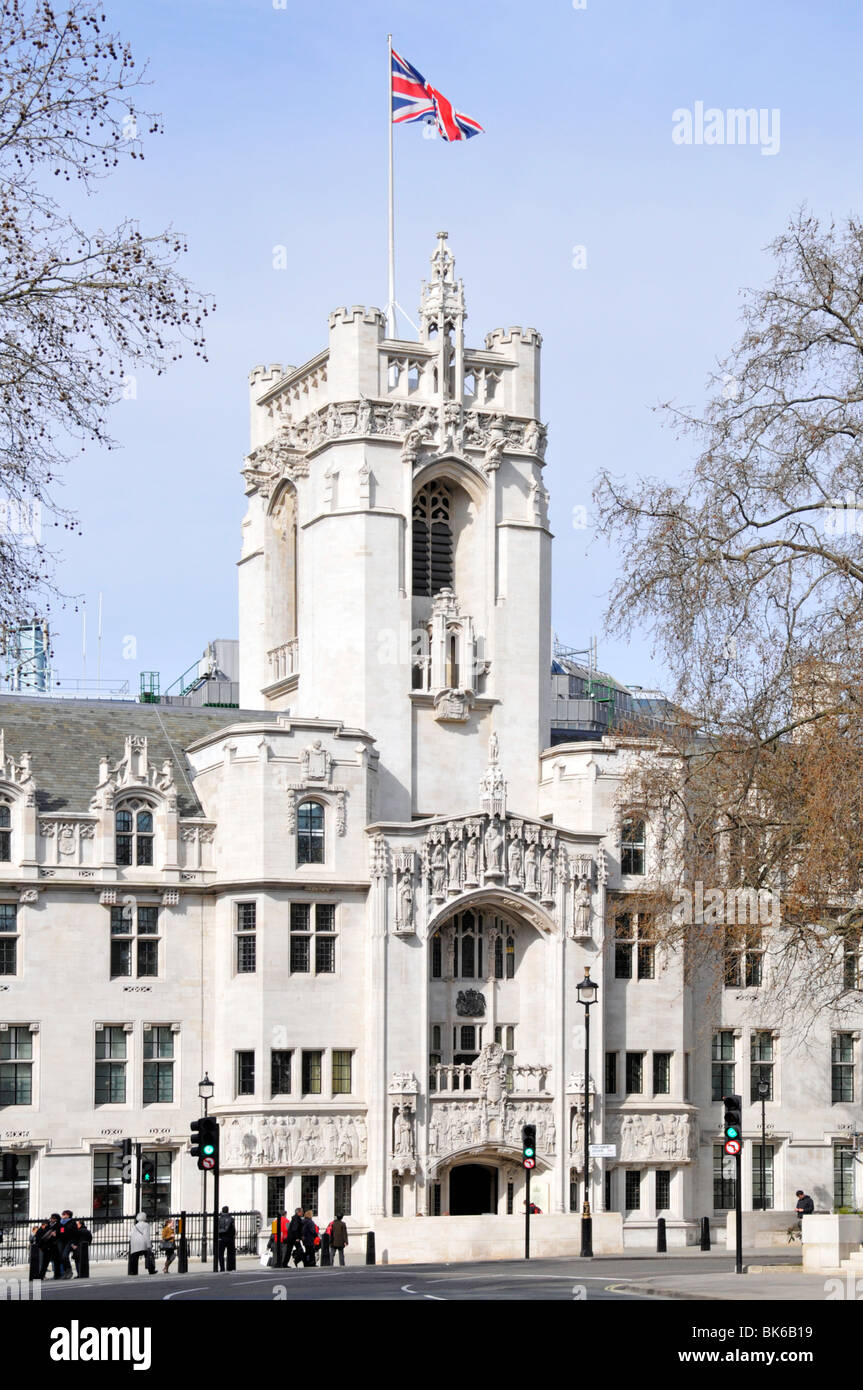 Union Jack Flag flying clear blue sunny day above tower of old Middlesex Guildhall building now UK Supreme court in Parliament Square London England Stock Photo