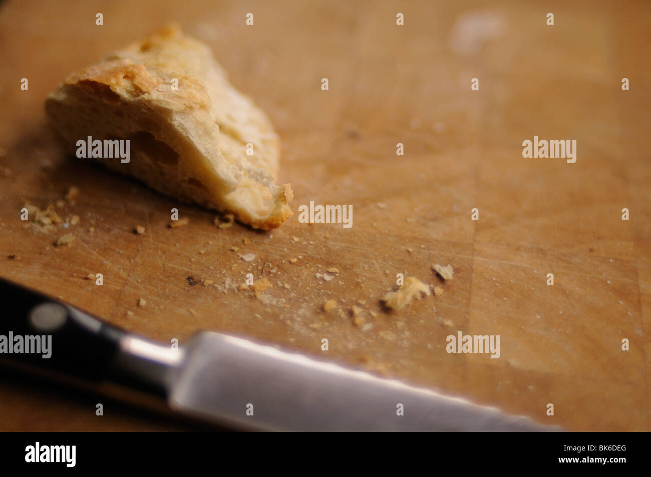 White bread slice and knife on a cutting board Stock Photo