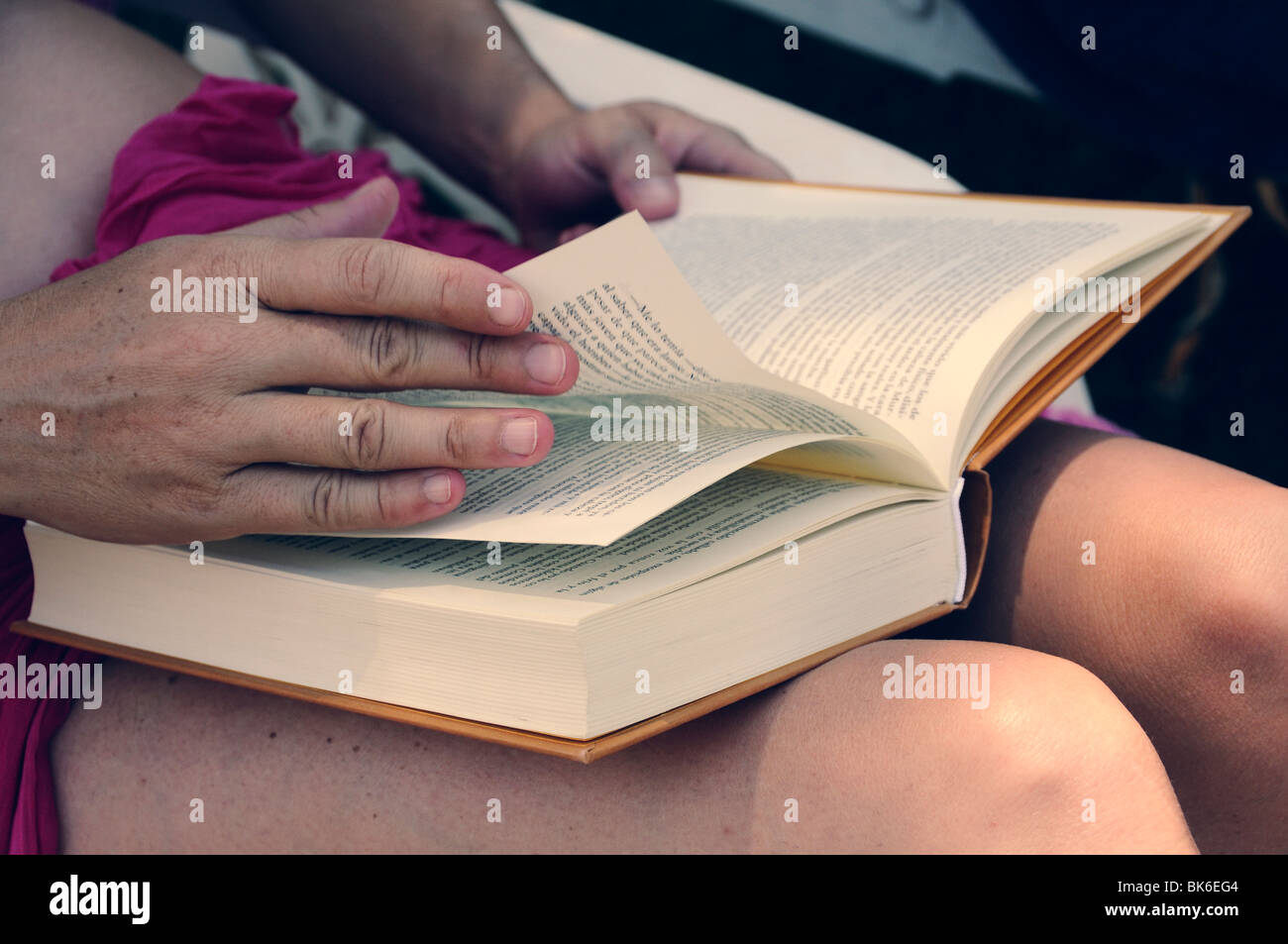 Close-up of a young woman hands reading a book Stock Photo
