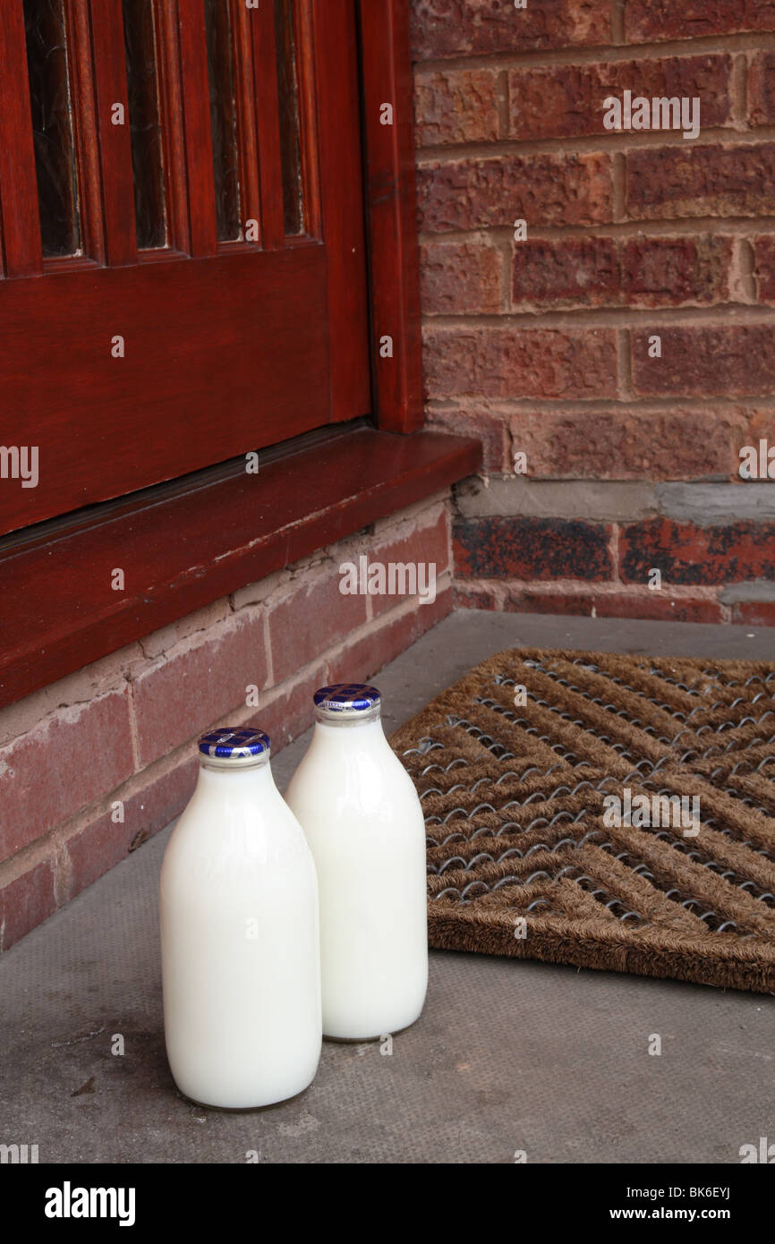 Milk Bottles by Front Doorstep, Close Up, UK Stock Photo