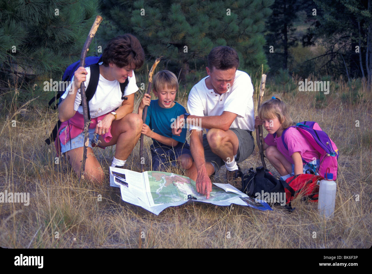 released family hiking navigating using map and compass Stock Photo Alamy