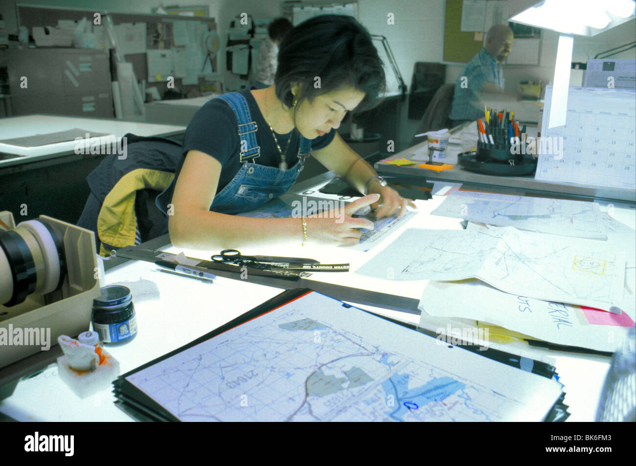 cartographer Asian woman working on street map Stock Photo