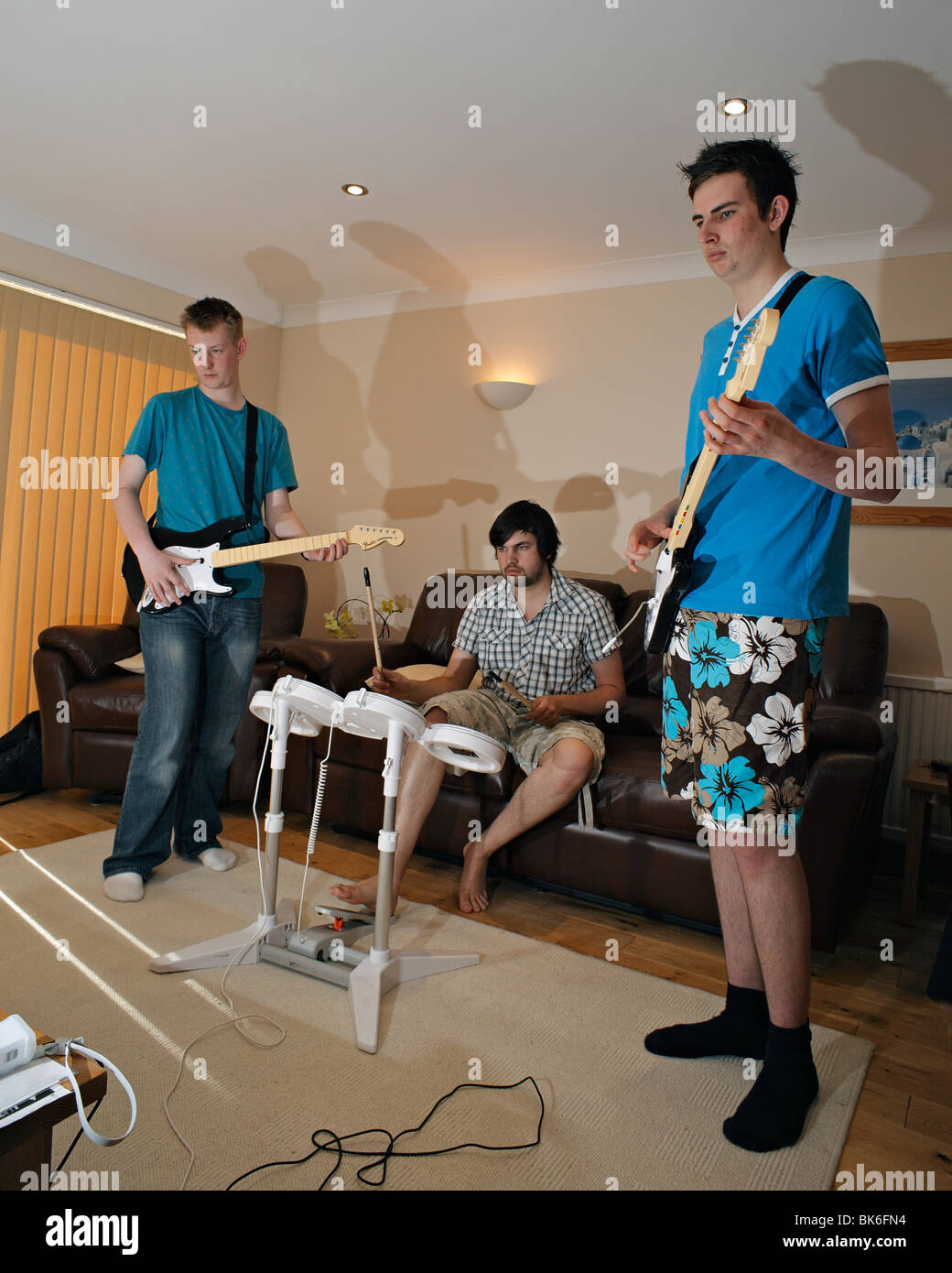 Teenagers playing Rock Band computer game. Stock Photo