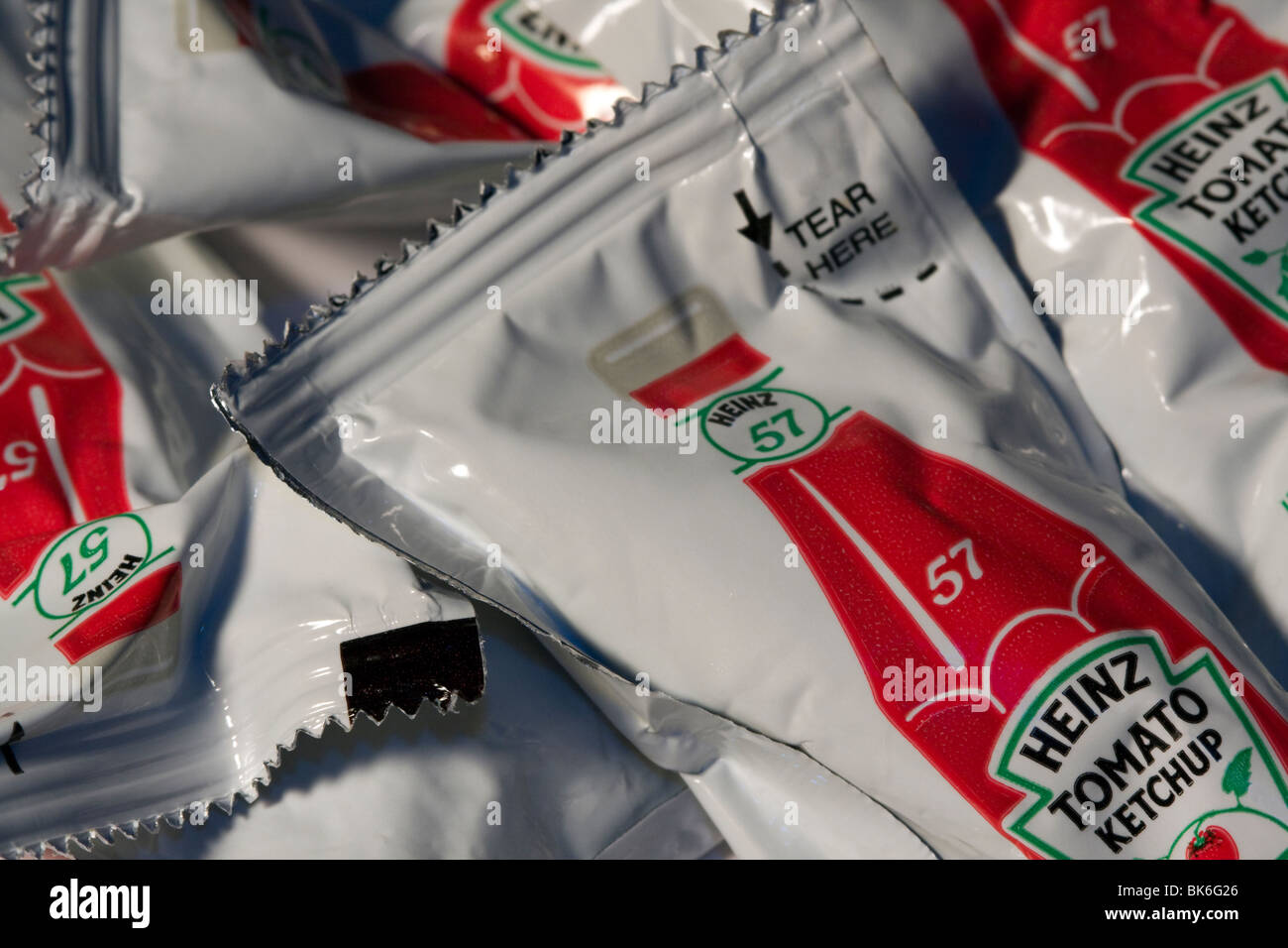 Close Up of Single Serve Heinz Tomato Ketchup Packets. Stock Photo