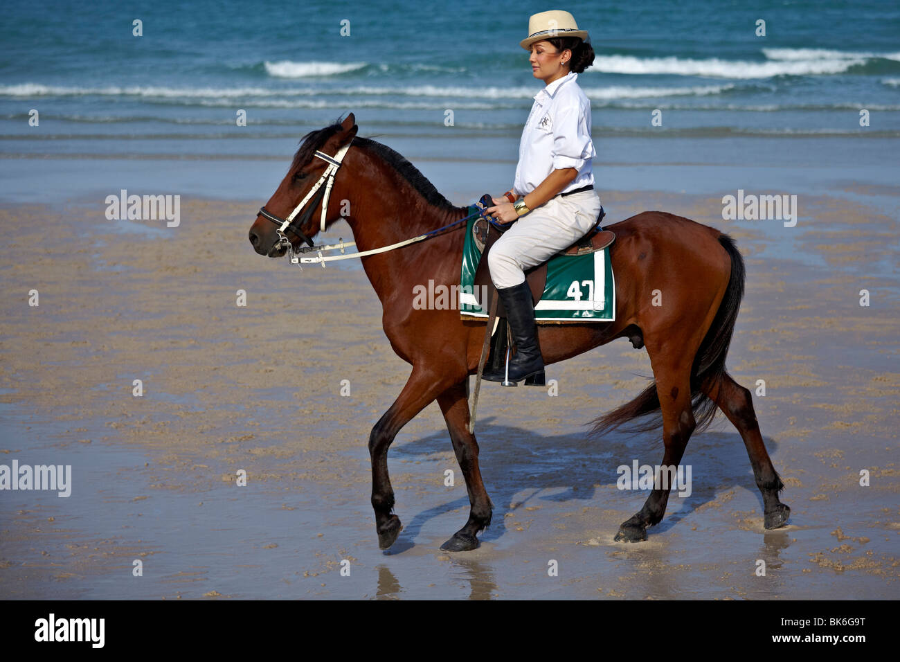 Woman riding a horse on a Thailand beach Stock Photo