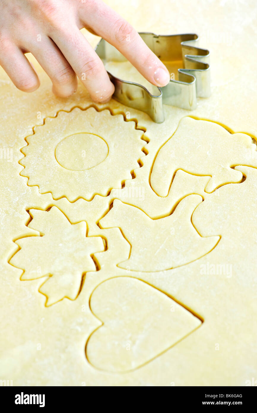 Cutting cookie shapes in rolled dough with cutter Stock Photo Alamy