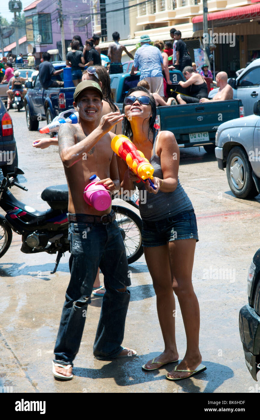 Thai man putting talc powder on a ladies face during Songkran festival Koh Phangan Thailand Stock Photo