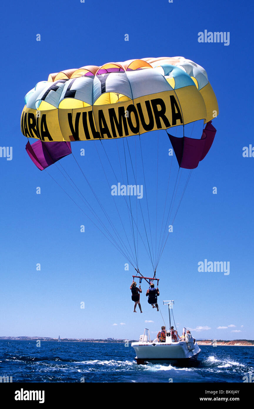 Holiday makers taking part in parascending activities off the coast of Vilamoura, in Portugal's Algarve province Stock Photo