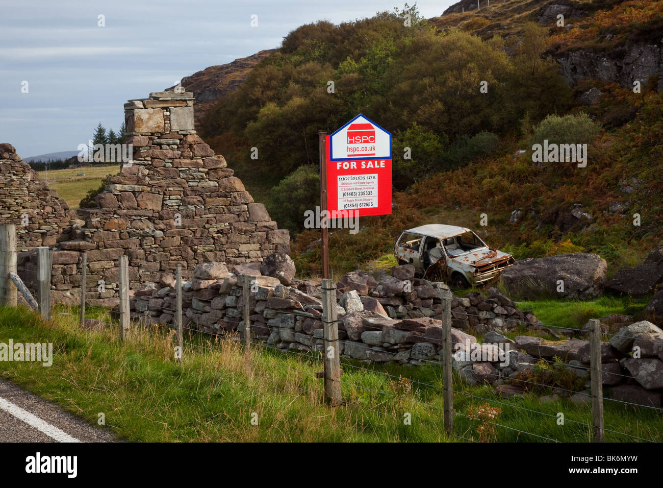 For sale board, Derelict roadside house, a ruined stone cottage in