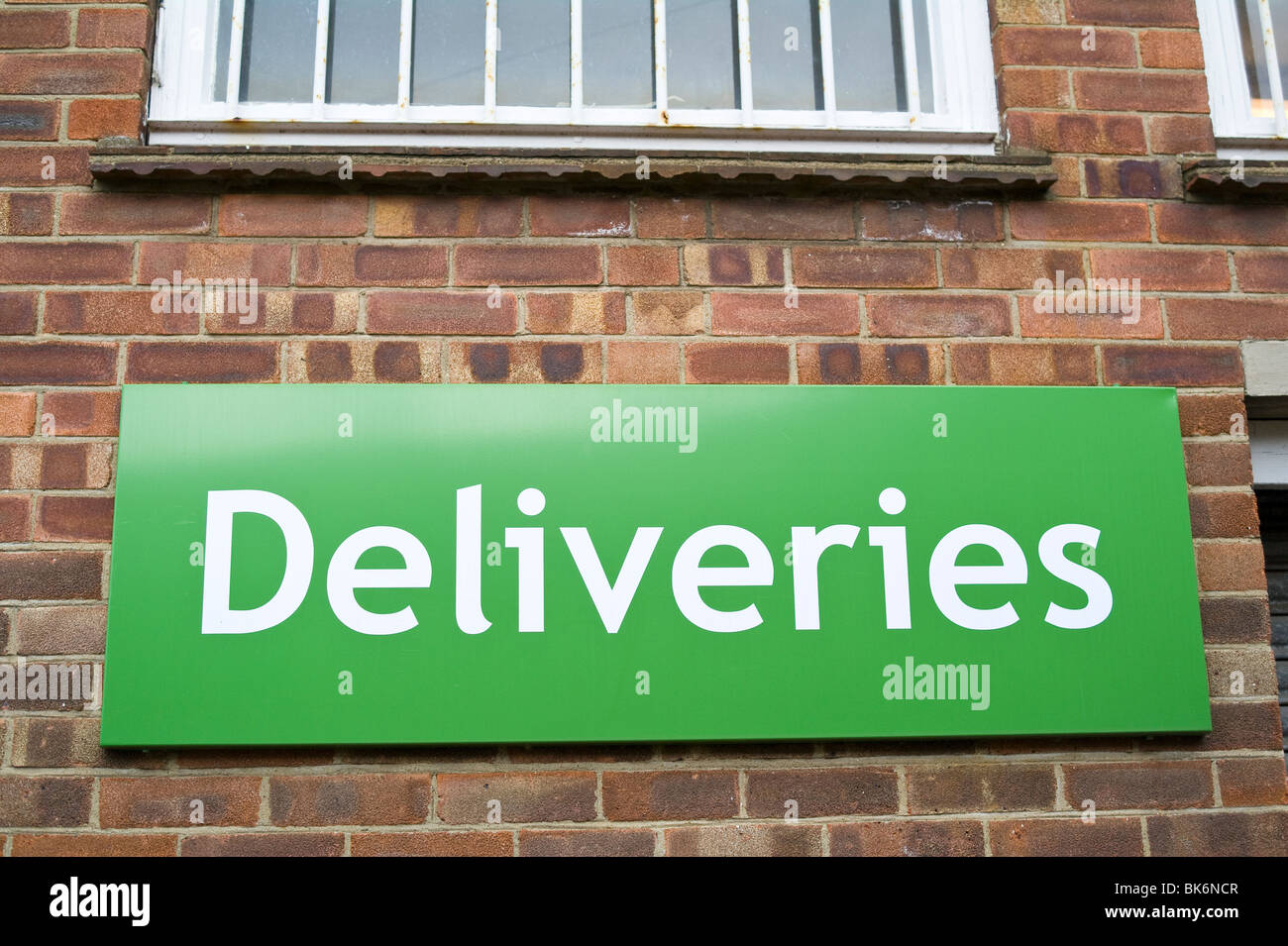 Deliveries Sign at Rear of Shop Stock Photo
