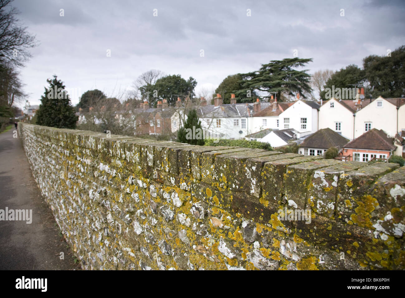 View from the Roman city wall along the foothpath and surrounding houses, Chichester, West Sussex, England. Stock Photo
