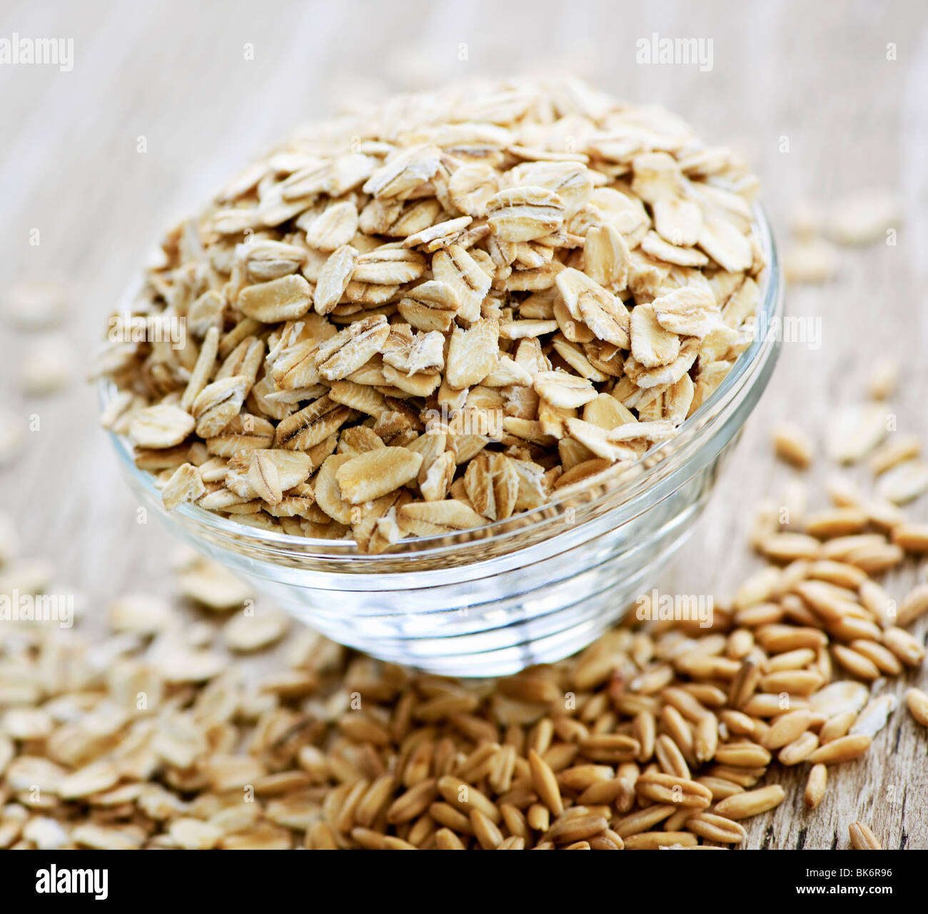 Nutritious rolled oats heaped in a glass bowl Stock Photo - Alamy