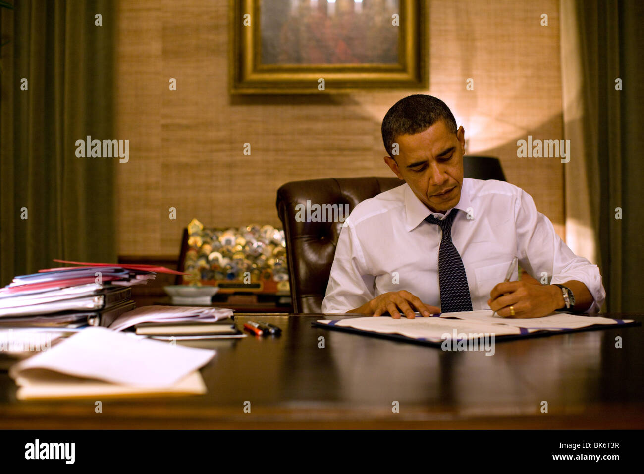 President Barack Obama signs H.R. 4691, Temporary Extension Act of 2010, in his private office in the White House residence. Stock Photo