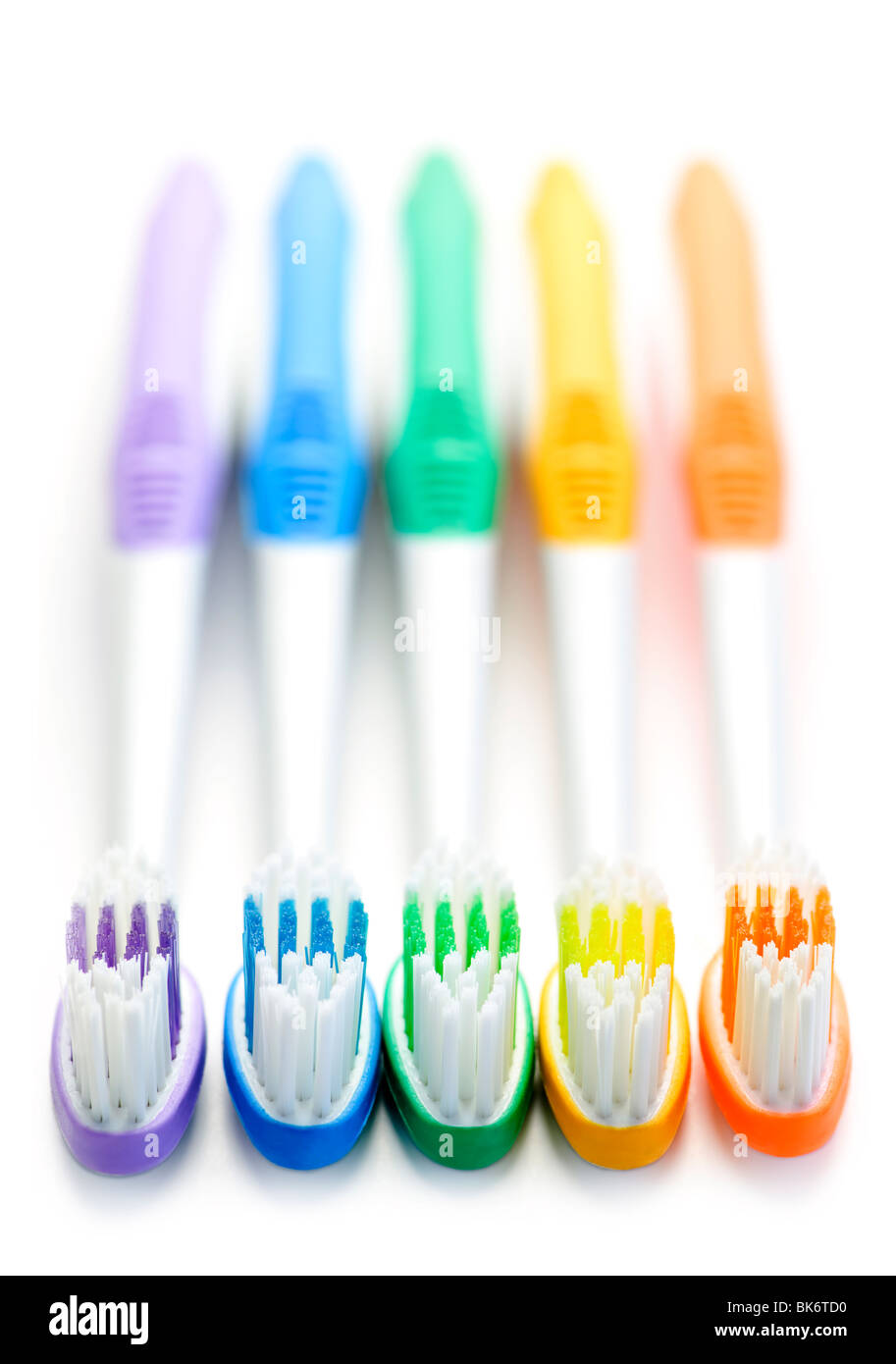 Close up of multicolored toothbrushes on white background Stock Photo