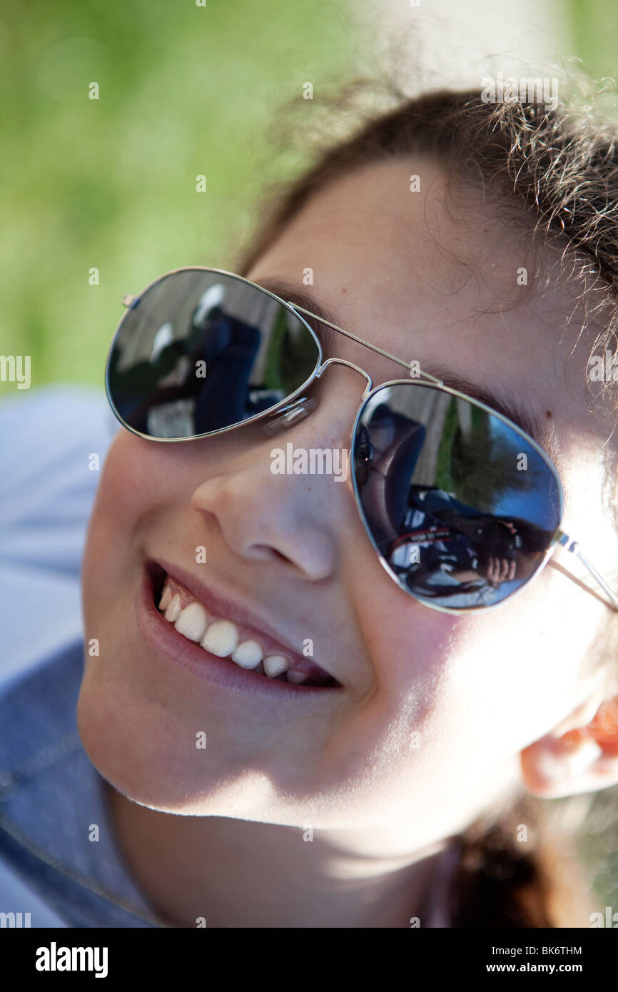 Young girl wearing sunglasses. Facial close up Stock Photo - Alamy